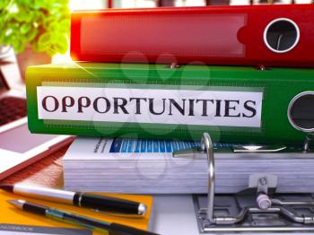 Opportunities - Green Office Folder on Background of Working Table with Stationery and Laptop. Opportunities Business Concept on Blurred Background. Opportunities Toned Image. 3D