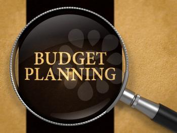 Budget Planning Concept through Magnifier on Old Paper with Black Vertical Line Background. 3d Render.