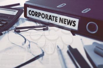 Corporate News - Office Folder on Background of Working Table with Stationery, Glasses, Reports. Business Concept on Blurred Background. Toned Image.