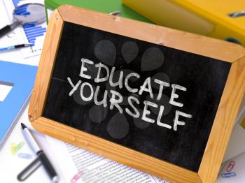Educate Yourself Handwritten by White Chalk on a Blackboard. Composition with Small Chalkboard on Background of Working Table with Office Folders, Stationery, Reports. Blurred, Toned Image. 3d Render.
