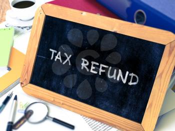 Tax Refund Concept Hand Drawn on Chalkboard on Working Table Background. Blurred Background. Toned Image. 3D Render.