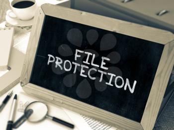 File Protection Handwritten on Chalkboard. Composition with Small Chalkboard on Background of Working Table with Ring Binders, Office Supplies, Reports. Blurred Background. Toned Image. 3D Render.