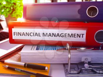 Financial Management - Red Office Folder on Background of Working Table with Stationary and Laptop. Financial Management Business Concept on Blurred Background. Financial Management Toned Image. 3D.