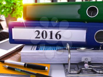 2016 - Blue Office Folder on Background of Working Table with Stationery and Laptop. 2016 Business Concept on Blurred Background. 2016 Toned Image. 3D.