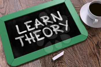 Learn Theory Concept Hand Drawn on Green Chalkboard on Wooden Table. Business Background. Top View. 3D Render.