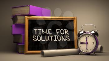 Time for Solutions - Chalkboard with Hand Drawn Text, Stack of Books, Alarm Clock and Rolls of Paper on Blurred Background. Toned Image. 3D Render.