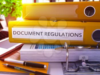 Yellow Ring Binder with Inscription Document Regulations on Background of Working Table with Office Supplies and Laptop. Document Regulations Business Concept on Blurred Background. 3D Render.
