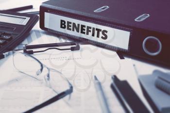 Benefits - Ring Binder on Office Desktop with Office Supplies. Business Concept on Blurred Background. Toned Illustration.