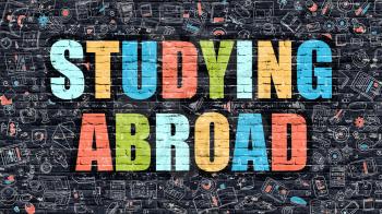 Multicolor Concept - Studying Abroad on Dark Brick Wall with Doodle Icons. Modern Illustration in Doodle Style. Studying Abroad Business Concept. Studying Abroad on Dark Wall.