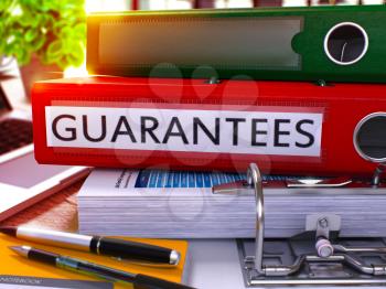 Guarantees - Red Ring Binder on Office Desktop with Office Supplies and Modern Laptop. Guarantees Business Concept on Blurred Background. Guarantees - Toned Illustration. 3D Render.