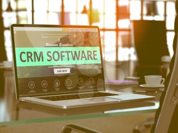 CRM - Customer Relationship Management - Software Concept. Closeup Landing Page on Laptop Screen  on background of Comfortable Working Place in Modern Office. Blurred, Toned Image. 3D Render.
