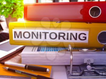 Monitoring - Yellow Ring Binder on Office Desktop with Office Supplies and Modern Laptop. Monitoring Business Concept on Blurred Background. Monitoring - Toned Illustration. 3D Render.