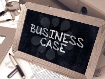 Business Case Handwritten by White Chalk on a Blackboard. Composition with Small Chalkboard on Background of Working Table with Office Folders, Stationery, Reports. Blurred, Toned Image. 3D Render.