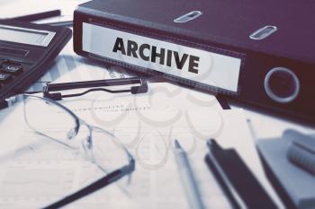 Archive - Ring Binder on Office Desktop with Office Supplies. Business Concept on Blurred Background. Toned Illustration.