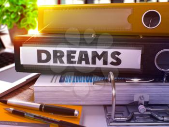 Dreams - Black Office Folder on Background of Working Table with Stationery and Laptop. Dreams Business Concept on Blurred Background. Dreams Toned Image. 3D.