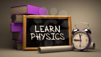 Learn Physics Handwritten on Chalkboard. Time Concept. Composition with Chalkboard and Stack of Books, Alarm Clock and Scrolls on Blurred Background. Toned Image. 3D Render.