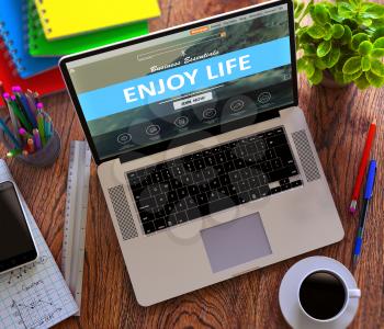 Enjoy Life Concept. Modern Laptop and Different Office Supply on Wooden Desktop background. 3D Render.