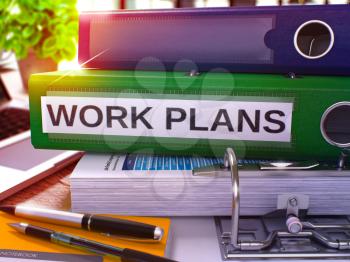 Work Plans - Green Office Folder on Background of Working Table with Stationery and Laptop. Work Plans Business Concept on Blurred Background. Work Plans Toned Image. 3D.