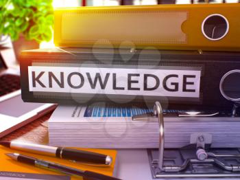 Black Office Folder with Inscription Knowledge on Office Desktop with Office Supplies and Modern Laptop. Knowledge Business Concept on Blurred Background. Knowledge - Toned Image. 3D.