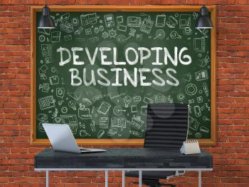 Developing Business - Handwritten Inscription by Chalk on Green Chalkboard with Doodle Icons Around. Business Concept in the Interior of a Modern Office on the Red Brick Wall Background. 3D.