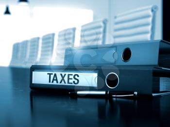 Taxes - Business Concept. Taxes - Business Concept on Blurred Background. Office Folder with Inscription Taxes on Black Desktop. Taxes - Office Binder on Wooden Office Desk. 3D.