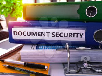 Blue Ring Binder with Inscription Document Security on Background of Working Table with Office Supplies and Laptop. Document Security Business Concept on Blurred Background. 3D Render.