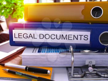Blue Office Folder with Inscription Legal Documents on Office Desktop with Office Supplies and Modern Laptop. Legal Documents Business Concept on Blurred Background. Legal Documents - Toned Image. 3D.