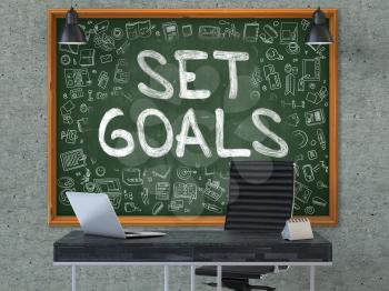 Green Chalkboard with the Text Set Goals Hangs on the Gray Concrete Wall in the Interior of a Modern Office. Illustration with Doodle Style Elements. 3D.