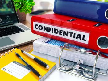 Confidential - Red Ring Binder on Office Desktop with Office Supplies and Modern Laptop. Business Concept on Blurred Background. Toned Illustration. 3D Render.