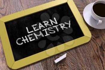 Learn Chemistry Handwritten by white Chalk on a Blackboard. Composition with Small Yellow Chalkboard and Cup of Coffee. Top View. 3D Render.