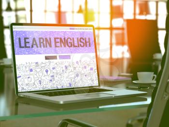 Learn English Concept. Closeup Landing Page on Laptop Screen in Doodle Design Style. On Background of Comfortable Working Place in Modern Office. Blurred, Toned Image. 3D Render.