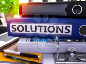 Solutions - Blue Ring Binder on Office Desktop with Office Supplies and Modern Laptop. Solutions Business Concept on Blurred Background. Solutions - Toned Illustration. 3D Render.