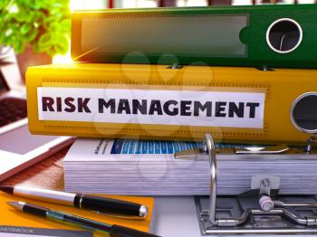 Risk Management - Yellow Ring Binder on Office Desktop with Office Supplies and Modern Laptop. Risk Management Business Concept on Blurred Background. Risk Management - Toned Illustration. 3D Render.