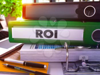 Green Office Folder with Inscription ROI - Return on Investment - on Office Desktop with Office Supplies and Modern Laptop. ROI Business Concept on Blurred Background. ROI- Toned Image. 3D