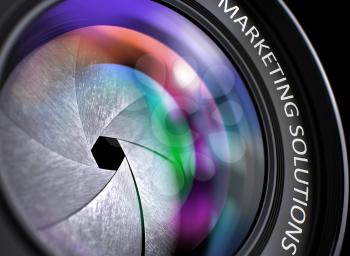 Marketing Solutions Concept. Closeup of a Lens of Digital Camera with Beautiful Color Lights Reflections. Marketing Solutions Written on a Photo Lens. 3D.