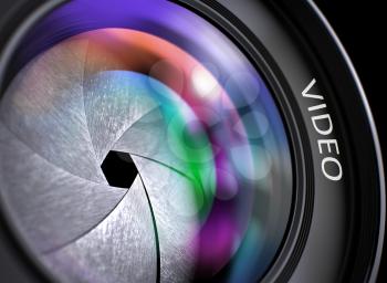 Video Written on a Front Glass of Camera Lens. SLR Camera Lens with Video Concept, Closeup. Lens Flare Effect. Lens of Camera with Video Inscription. Colorful Lens Flares on Front Glass. 3D.