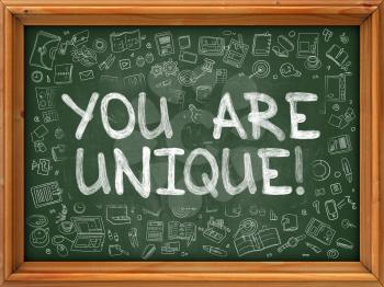 You are Unique - Hand Drawn on Chalkboard. You Are Unique with Doodle Icons Around.