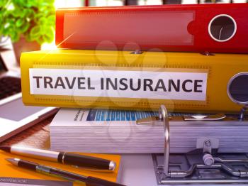 Travel Insurance - Yellow Ring Binder on Office Desktop with Office Supplies and Modern Laptop. Travel Insurance Business Concept on Blurred Background. 3D Render.