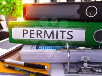 Permits - Green Office Folder on Background of Working Table with Stationery and Laptop. Permits Business Concept on Blurred Background. Permits Toned Image. 3D.