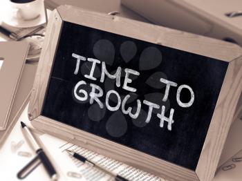 Time to Growth Handwritten by White Chalk on a Blackboard. Composition with Small Chalkboard on Background of Working Table with Office Folders, Stationery, Reports. Blurred, Toned Image. 3D Render.