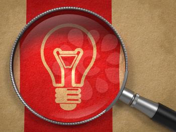 Magnifying Glass with Light Bulb Icon on Old Paper with Red Vertical Line Background. Idea Concept.