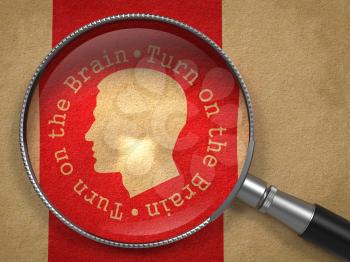 Magnifying Glass with Turn On the Brain Written Arround Human Head Icon on Old Paper with Red Vertical Line Background.