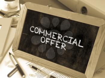 Commercial Offer Handwritten by White Chalk on a Blackboard. Composition with Small Chalkboard on Background of Working Table with Office Folders, Stationery, Reports. Blurred, Toned Image. 3D Render.