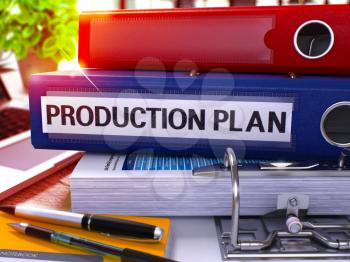 Blue Office Folder with Inscription Production Plan on Office Desktop with Office Supplies and Modern Laptop. Production Plan Business Concept on Blurred Background. Production Plan - Toned Image. 3D.