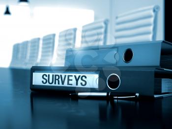Surveys - Business Illustration. Office Folder with Inscription Surveys on Desk. Surveys - Business Concept on Toned Background. 3D Render.