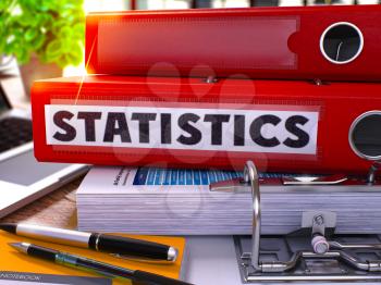Statistics - Red Office Folder on Background of Working Table with Stationery and Laptop. Statistics Business Concept on Blurred Background. Statistics Toned Image. 3D.