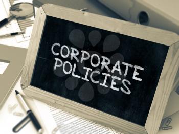 Corporate Policies Concept Hand Drawn on Chalkboard on Working Table Background. Blurred Background. Toned Image. 3D Render.