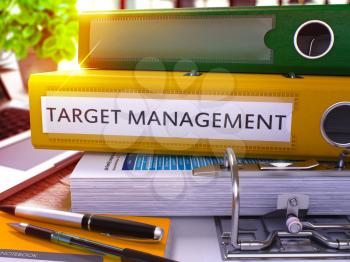 Target Management - Yellow Ring Binder on Office Desktop with Office Supplies and Modern Laptop. Target Management Business Concept on Blurred Background. 3D Render.