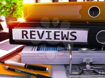 Reviews - Black Office Folder on Background of Working Table with Stationery and Laptop. Reviews Business Concept on Blurred Background. Reviews Toned Image. 3D.