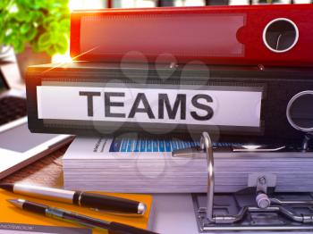 Teams - Black Office Folder on Background of Working Table with Stationery and Laptop. Teams Business Concept on Blurred Background. Teams Toned Image. 3D.